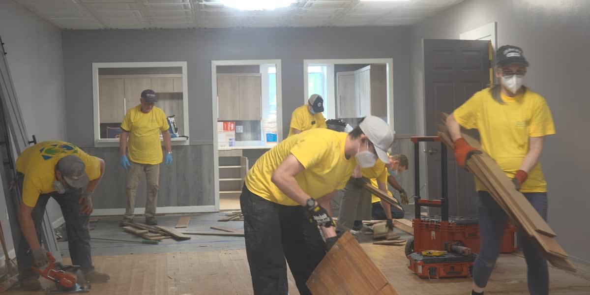 Volunteers in work clothes removing flood-damaged materials from West Virginia homes