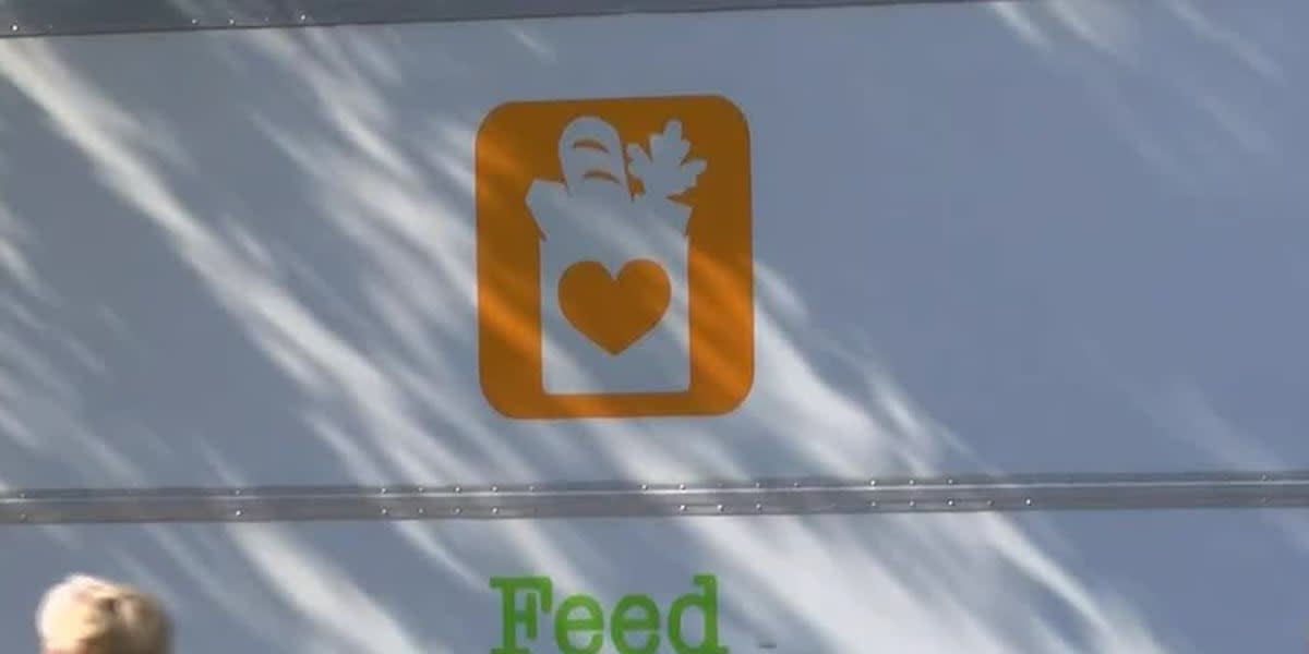 Volunteers organizing food boxes and groceries at community distribution center helping local families