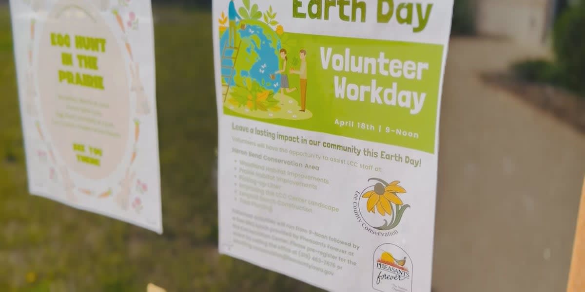 Volunteers wearing gloves picking up litter and restoring natural habitat at Iowa conservation area