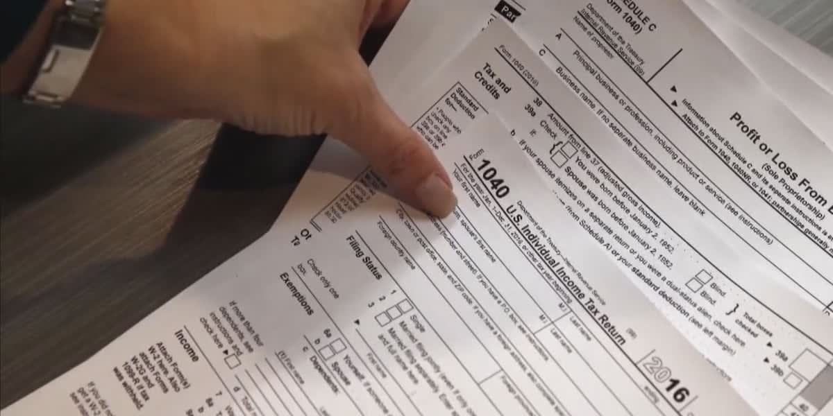 VITA volunteer helping community member complete tax forms at free preparation session in Topeka