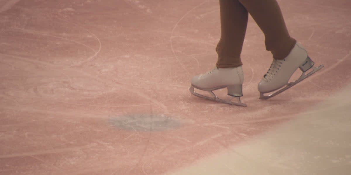 Oksana Baiul performing graceful figure skating move on ice in competition