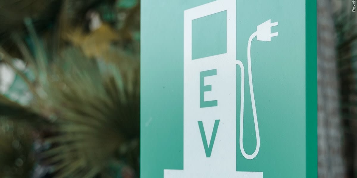 Modern electric vehicle charging station with multiple ports in public parking area