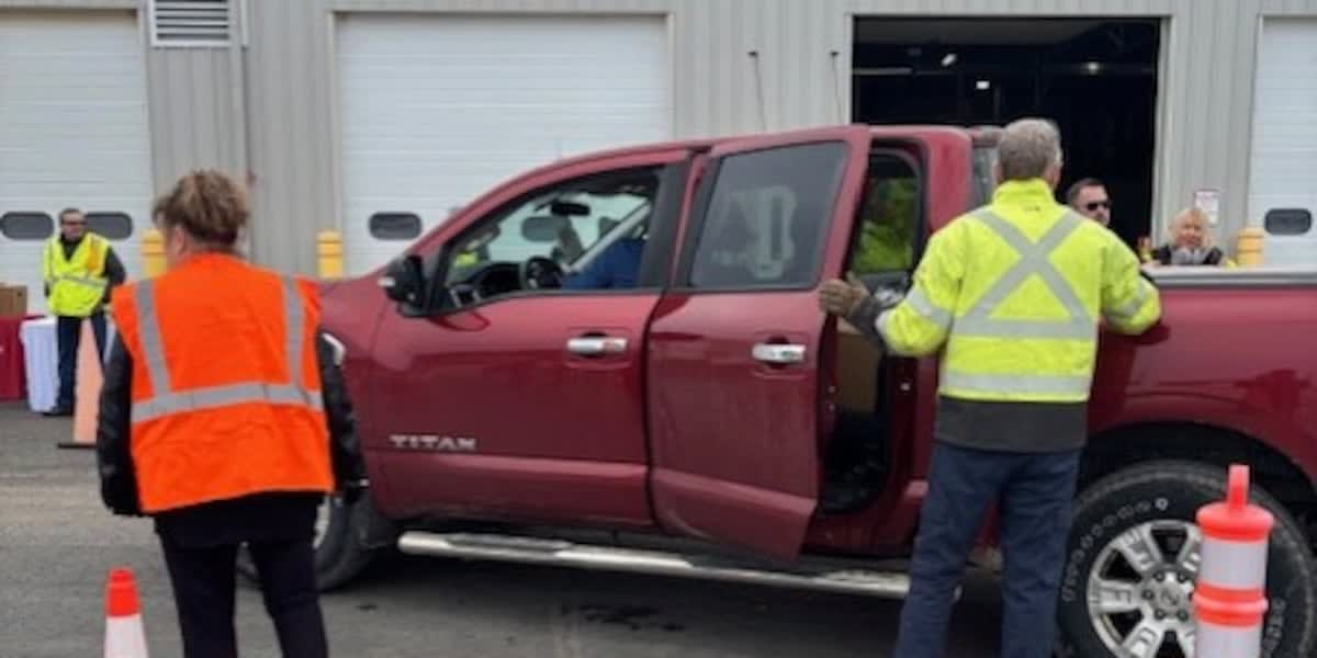 Volunteers loading Easter food baskets with hams and groceries for Delta County veterans in Michigan