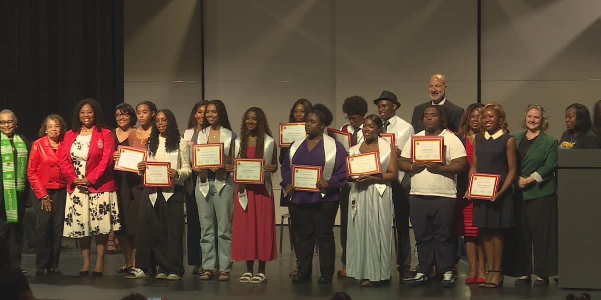 Students being recognized at awards ceremony in Madison high school auditorium