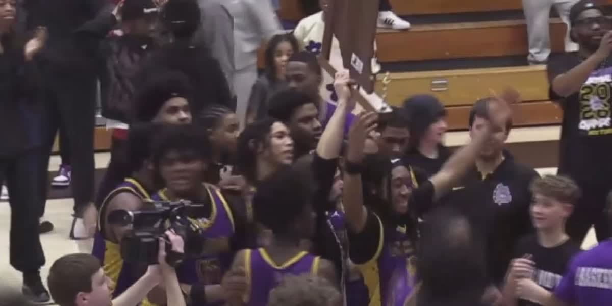 High school basketball players celebrating championship victory on indoor court with cheering crowd