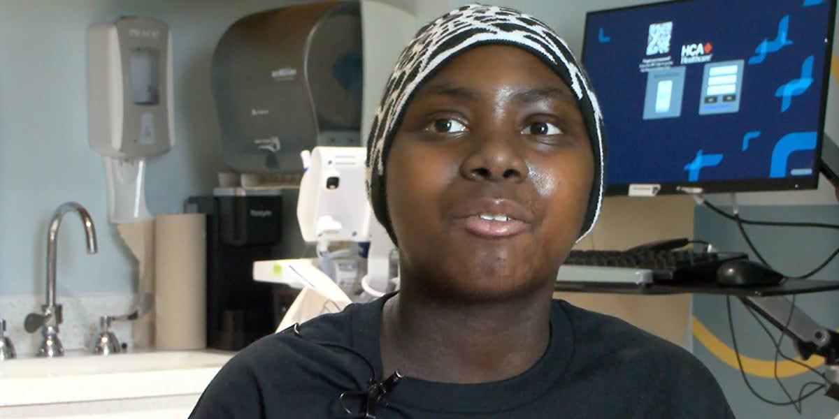 Teenage boy smiling in hospital bed after receiving groundbreaking sickle cell gene therapy treatment