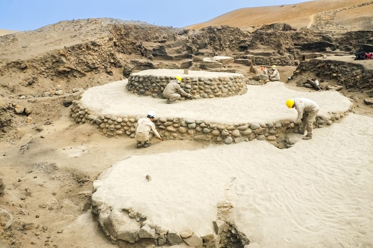 Restored stone platform structure at ancient Áspero archaeological site in Peru