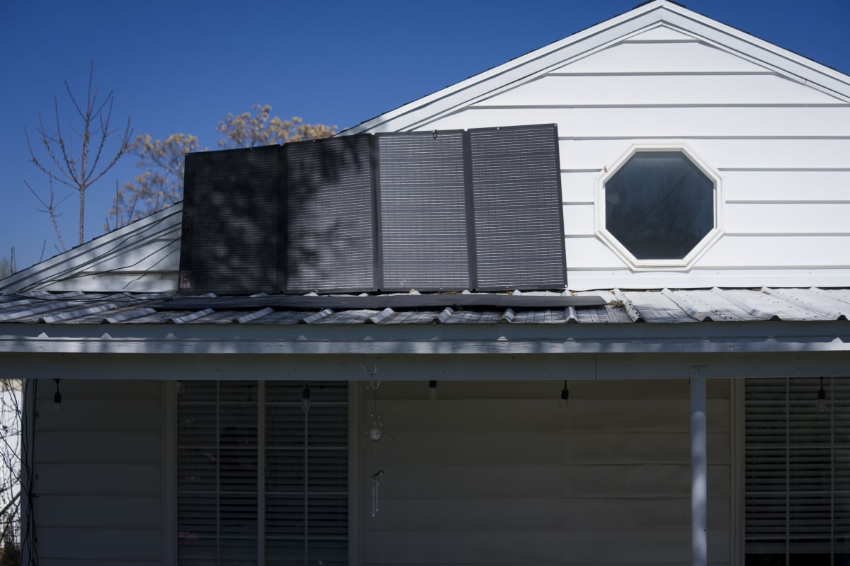 Solar panels mounted on apartment balcony railing generating clean electricity for residents