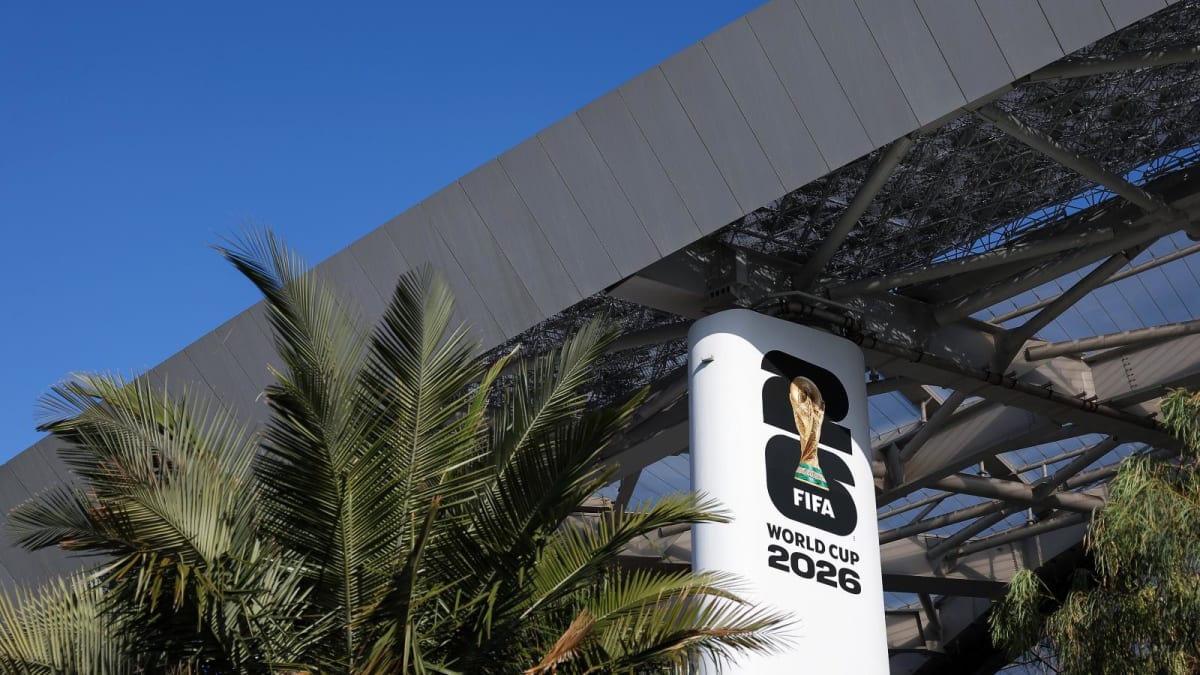 ** Modern SoFi Stadium with open roof panels and surrounding green landscaping in Los Angeles