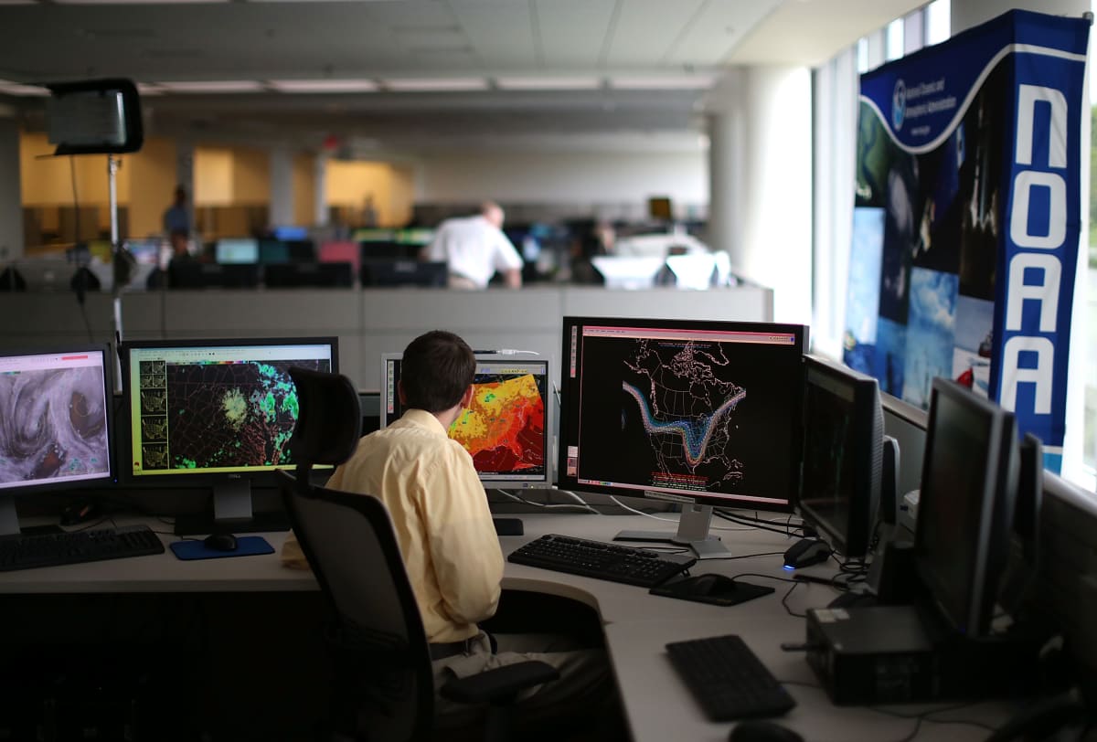 Scientists working together at computers to preserve climate data and educational resources online