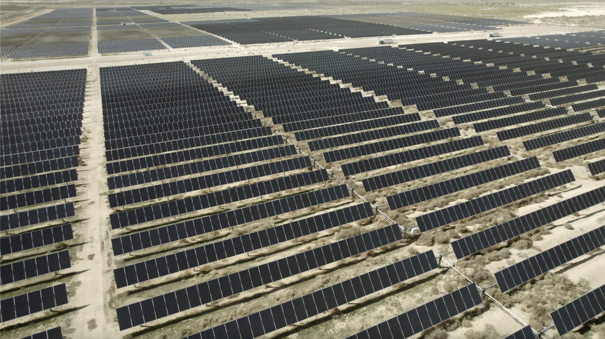 Solar panels stretching across Utah landscape under bright blue sky generating clean electricity