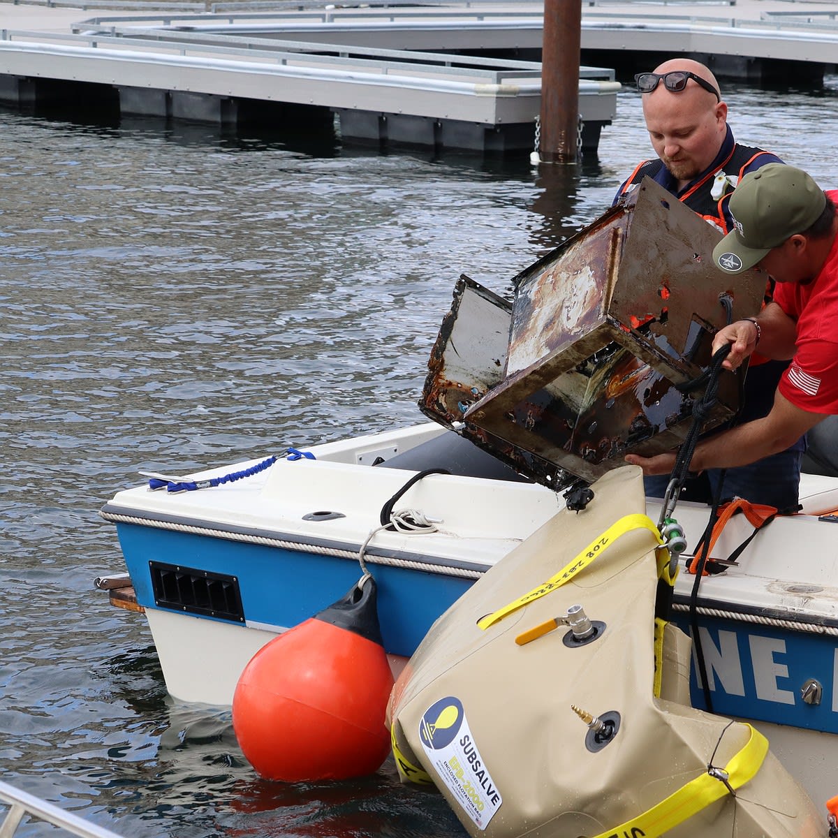 Volunteers pulling vintage tires from Lake Coeur d'Alene during community cleanup effort