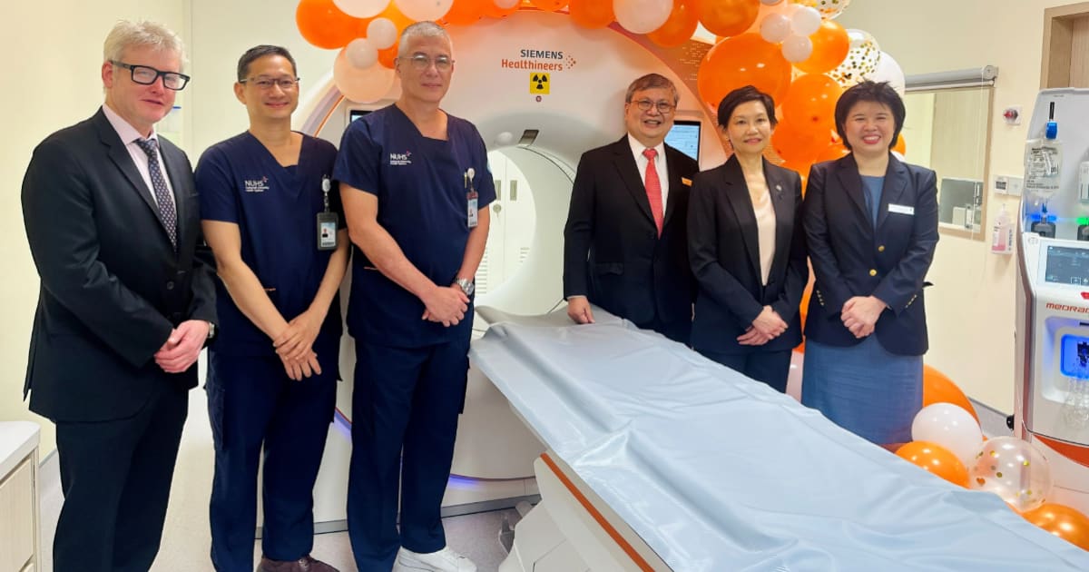 Modern medical CT scanner in hospital cardiac imaging room ready for patient scan