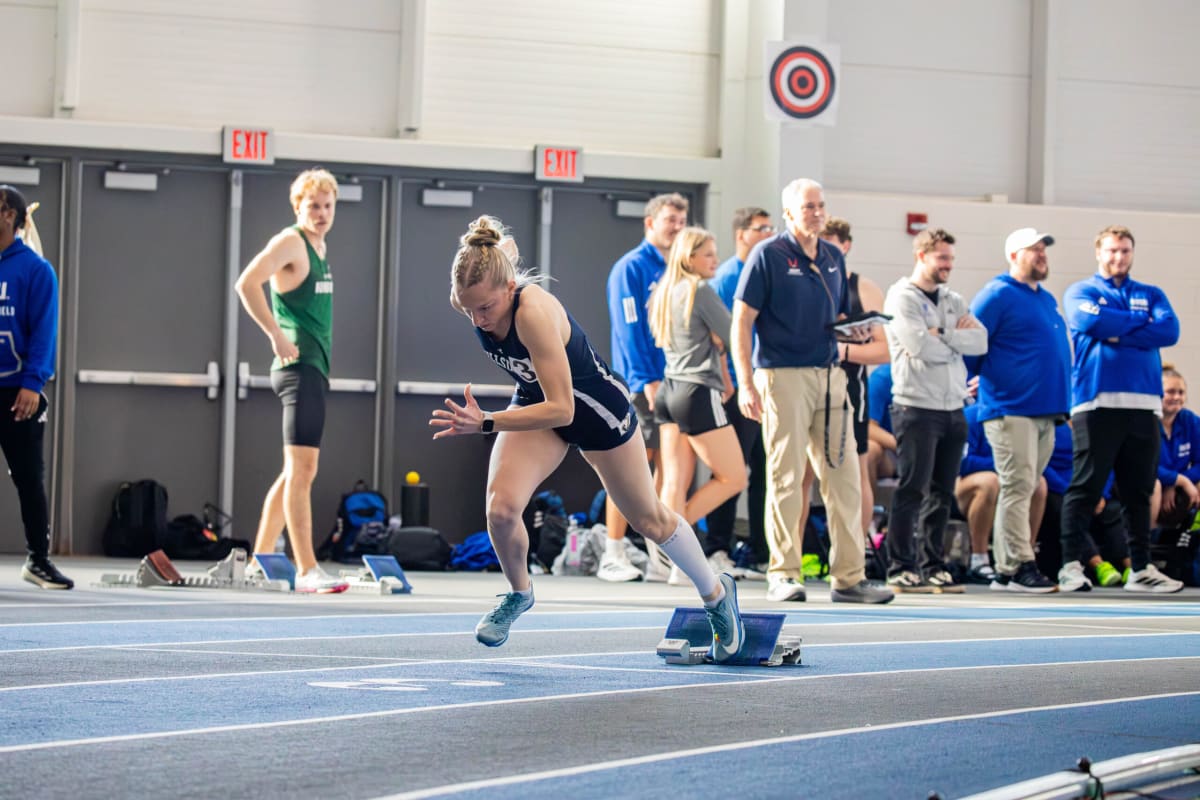 College freshman sprinter Anna Roessner racing in indoor track meet at Hillsdale College