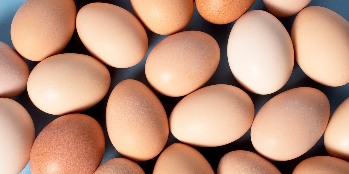 ** Colorful budget-friendly meal with eggs, beans, rice and seasoned vegetables on a plate