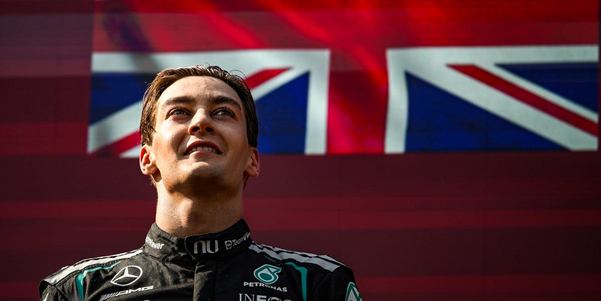 ** George Russell celebrating on podium after winning Austrian Grand Prix Formula 1 race