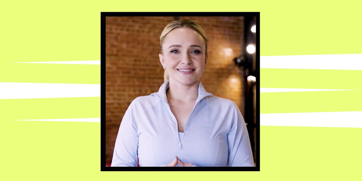 Hayden Panettiere performing barre workout exercises with her trainer in fitness studio