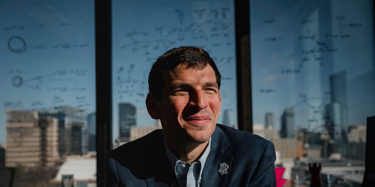 Dr. David Fajgenbaum working at computer analyzing medical data for rare disease treatments