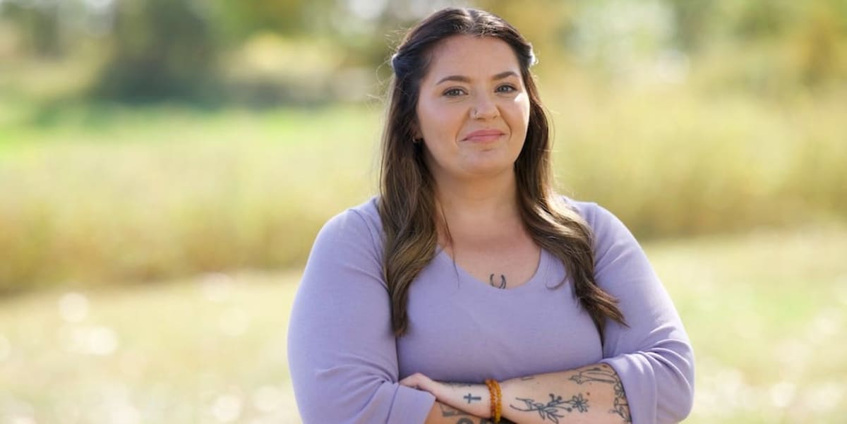 ** Smiling woman standing confidently outdoors after receiving proper mental health diagnosis and treatment