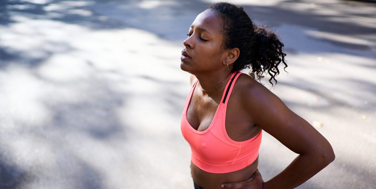 Runner resting on park bench after workout, demonstrating importance of recovery days