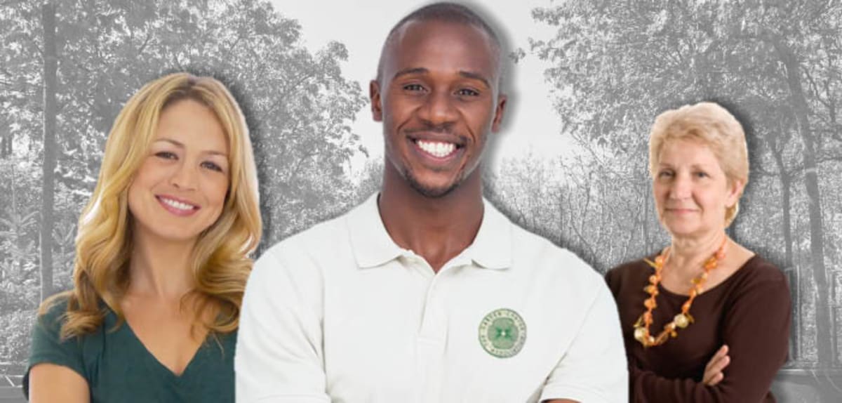 Garden center employee using laptop computer for online tree care training course