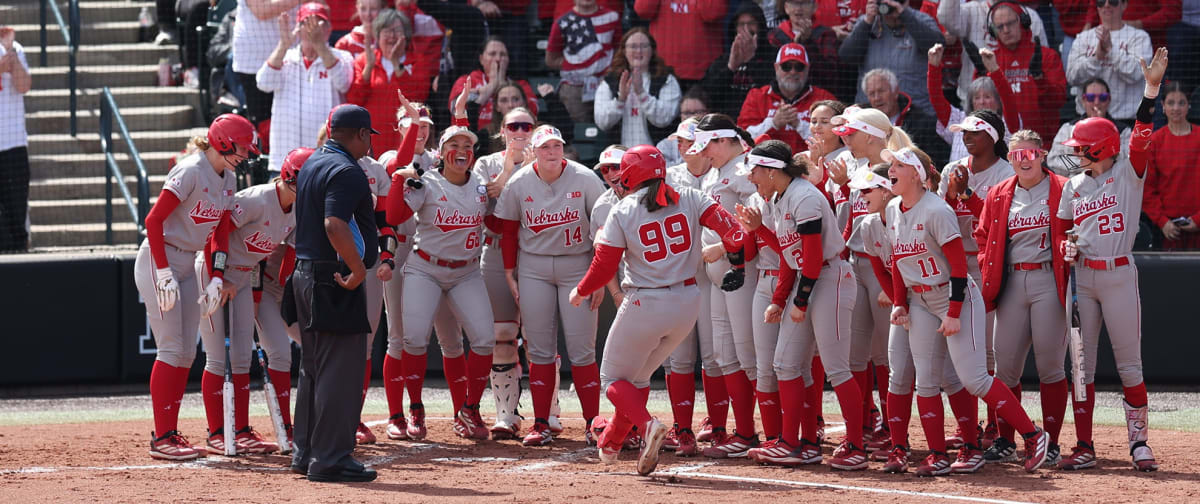 ** Nebraska softball players celebrating home run at Bowlin Stadium during UCLA game