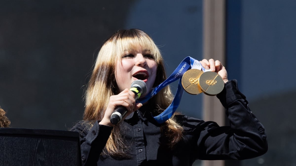 Alysa Liu holding two gold medals and smiling during celebration rally at Oakland City Hall