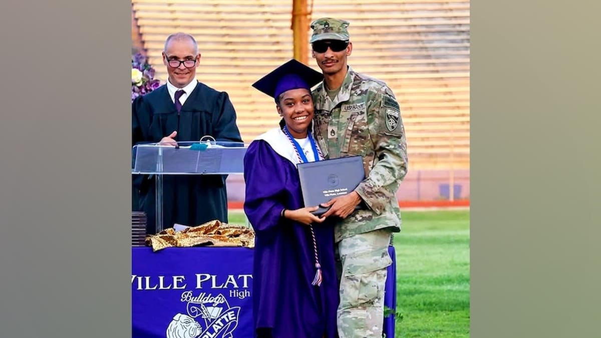 Staff Sergeant Brannavon Ardoin in military uniform hugging his daughter Jazlyn at graduation ceremony