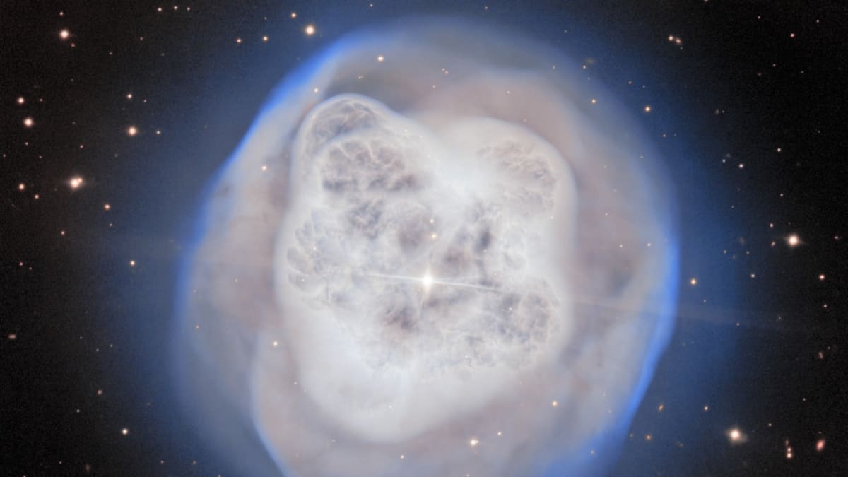 Spherical white glowing nebula cloud surrounding dying star system in deep space captured by telescope