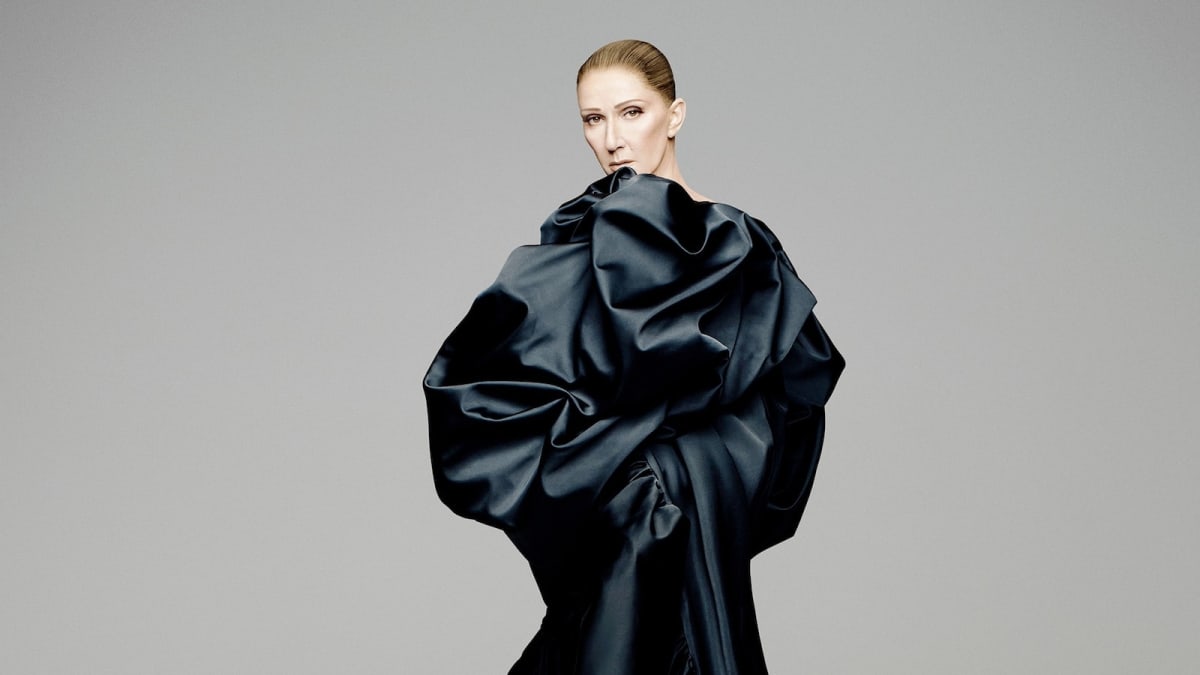 Celine Dion smiling confidently in promotional photo for her Paris comeback concert series