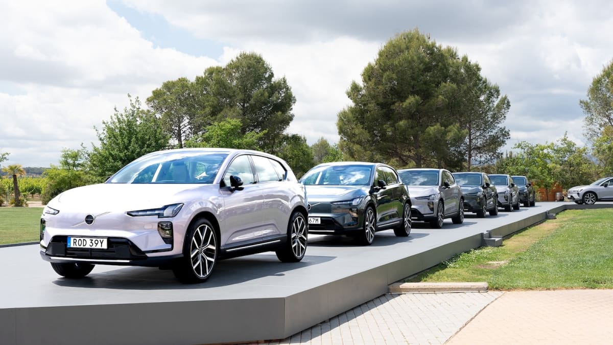 Sleek silver Volvo EX60 electric SUV with horizontal OLED display screen visible through windshield
