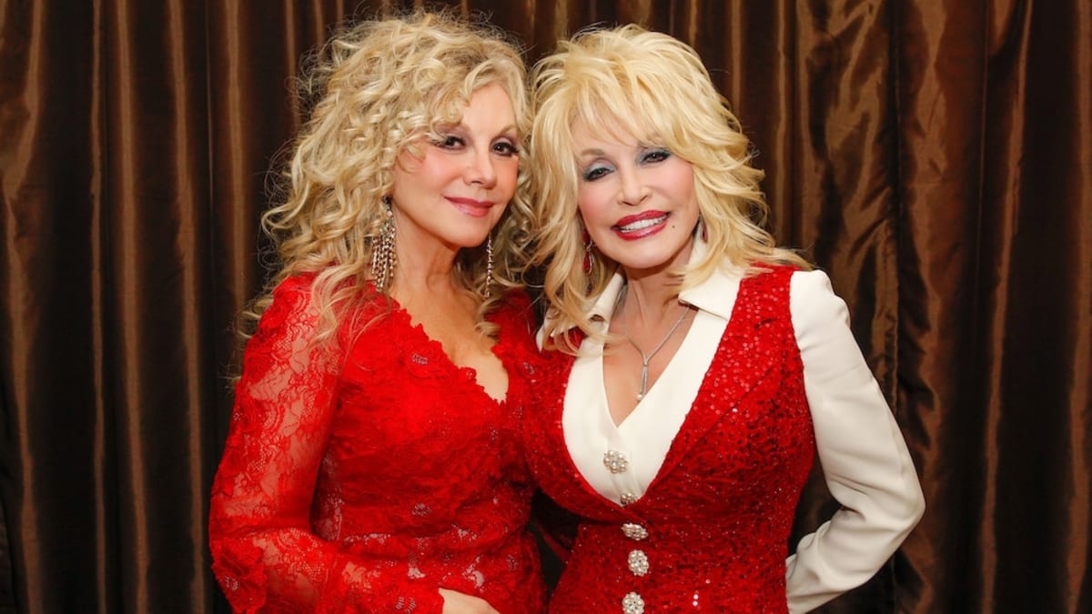 Dolly Parton and sister Stella Parton smiling together at Nashville event in 2014
