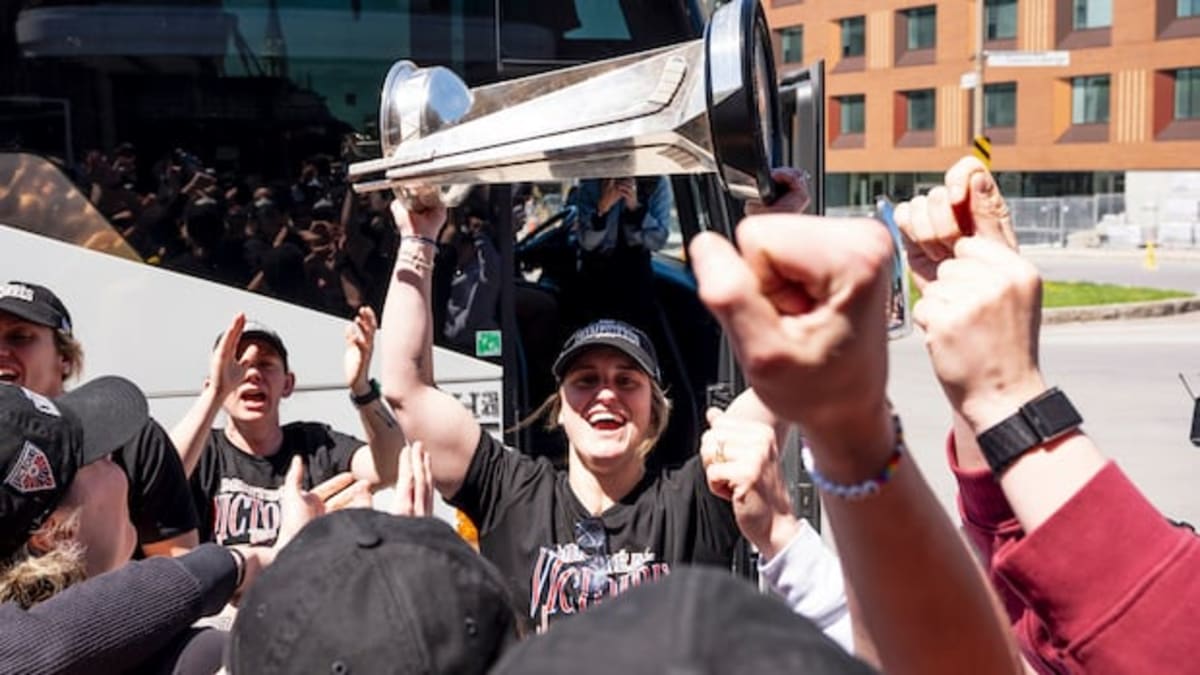 Marie-Philip Poulin holds the Walter Cup trophy high above her head celebrating championship victory