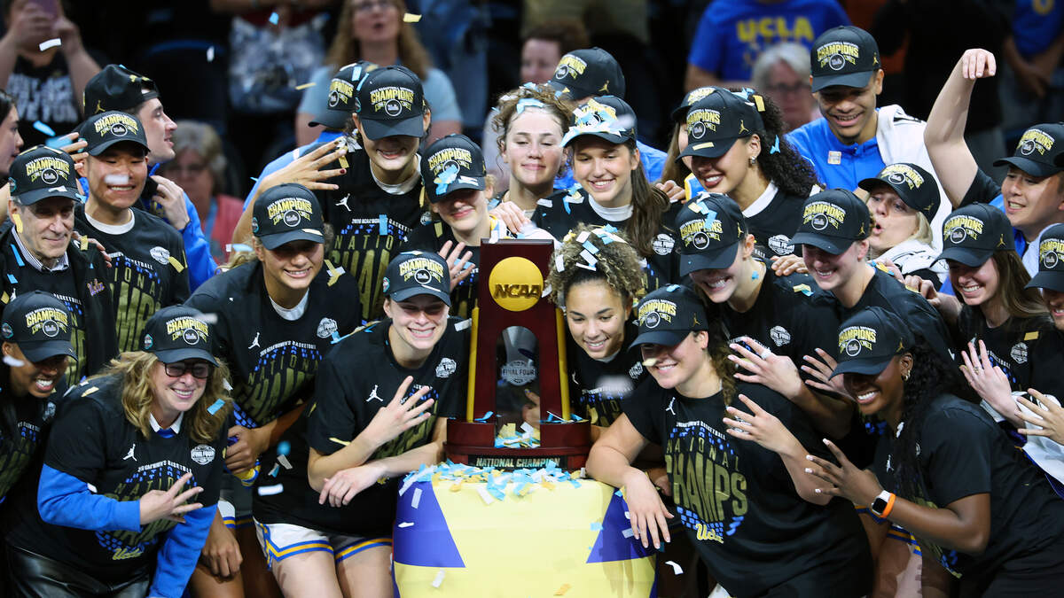 UCLA women's basketball team celebrates first NCAA championship trophy together on court
