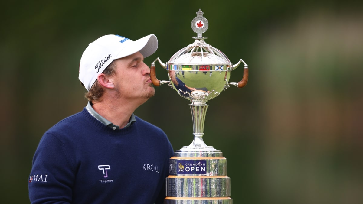 Golfer Bud Cauley celebrating with trophy at Canadian Open after first PGA Tour victory