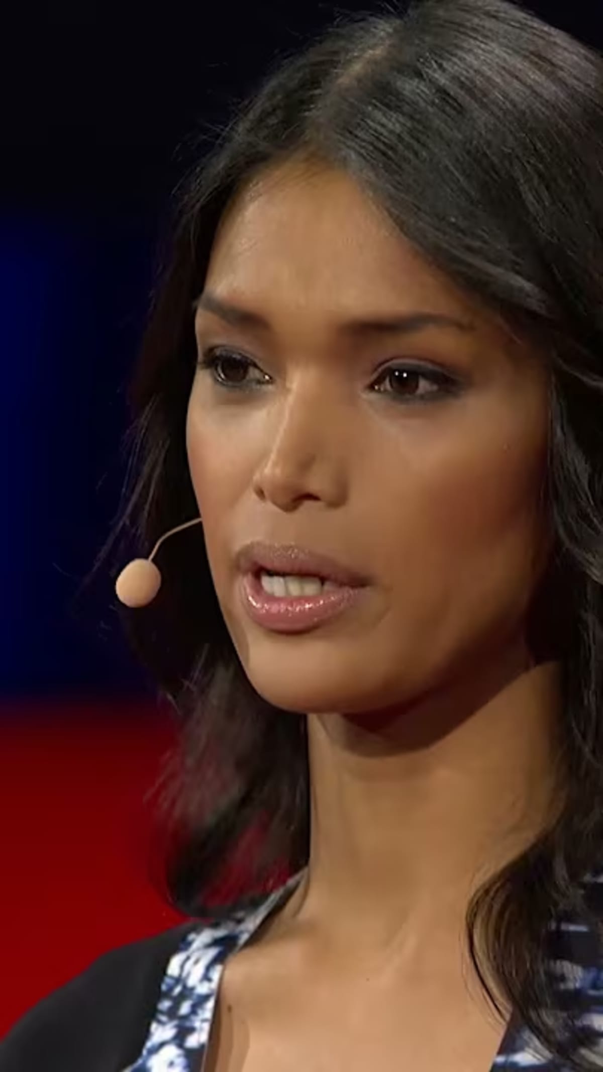 Fashion model Geena Rocero speaking confidently on the TED stage about her transgender journey