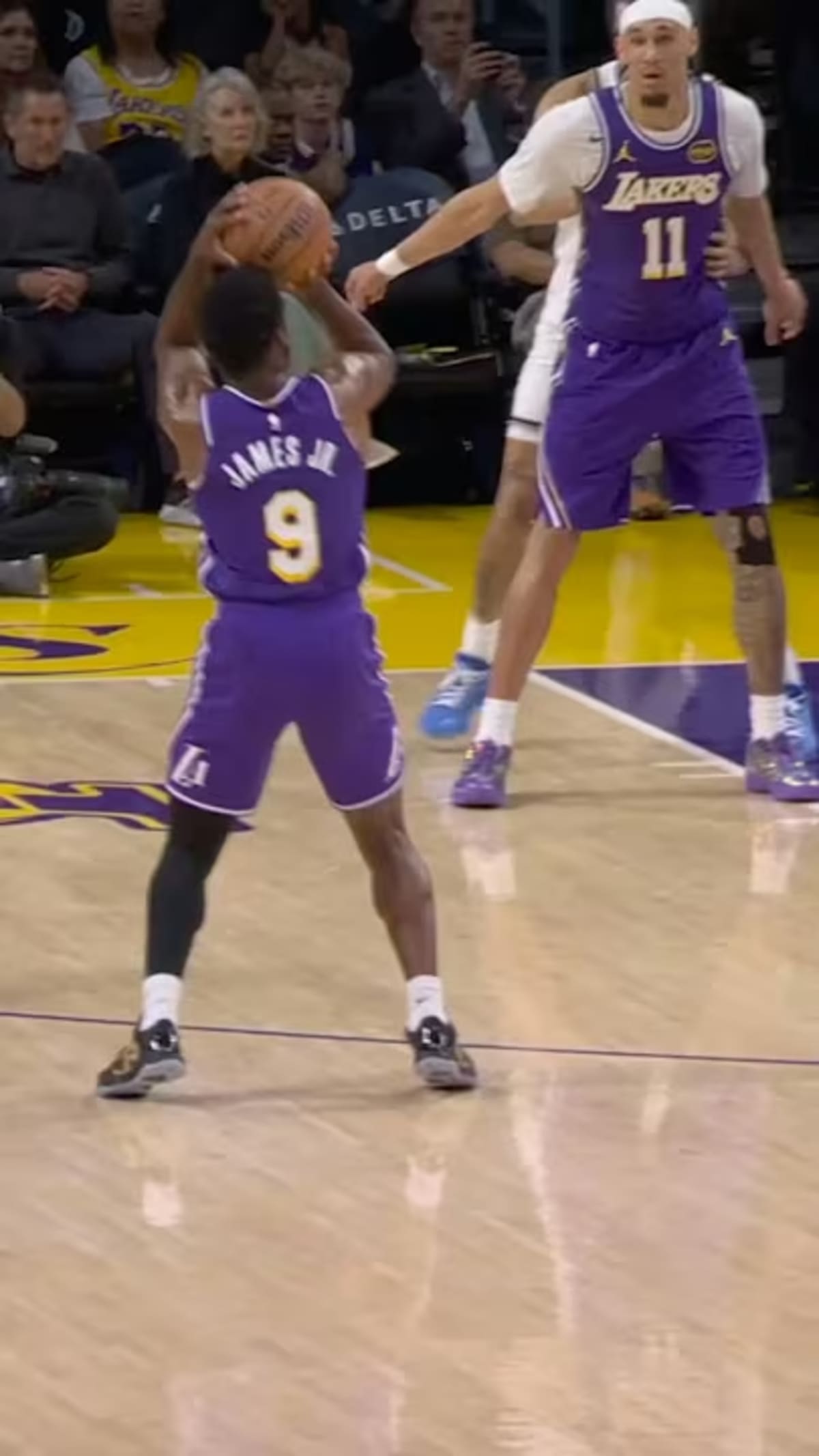 LeBron James passing basketball to his son Bronny James during Lakers game creating NBA history