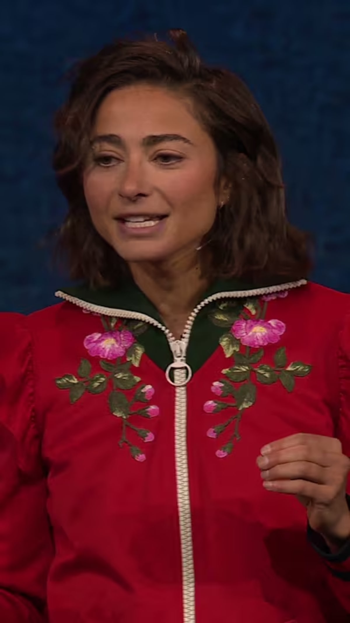Olympic runner Alexi Pappas speaking on TED stage about embracing difficult days
