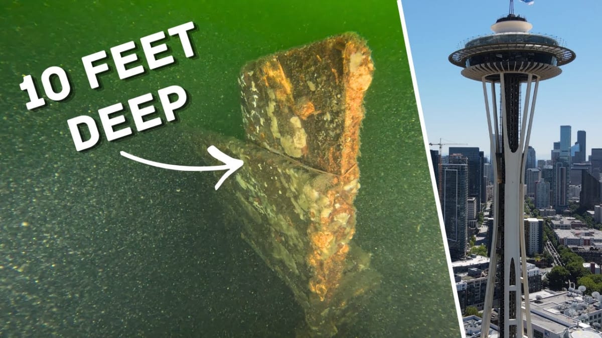 Underwater robot with lights exploring sunken steel workboat in murky Lake Union waters
