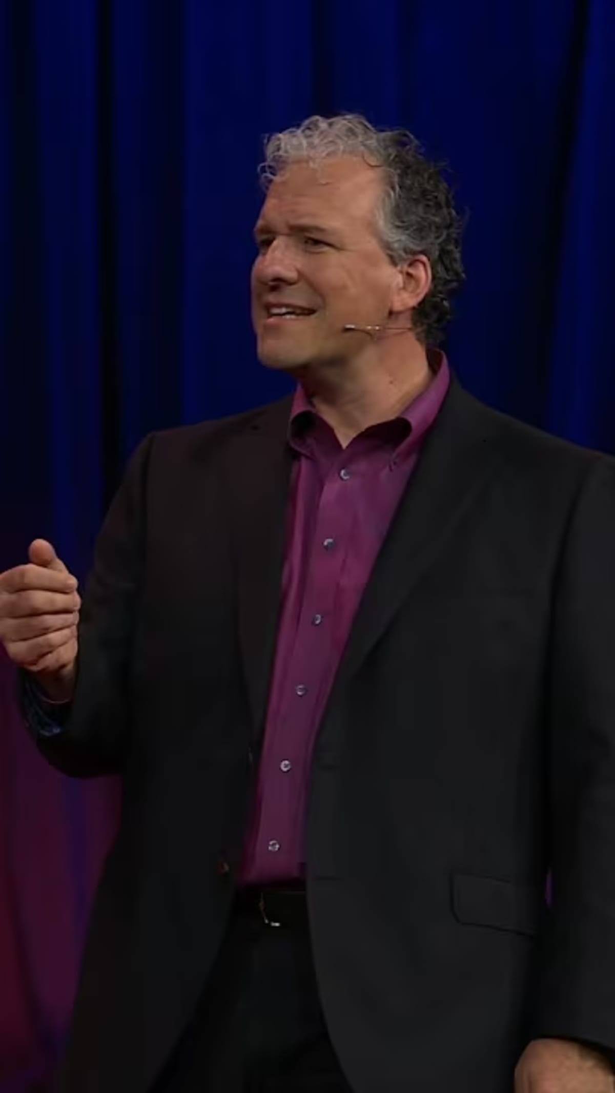 Two people smiling and talking face to face, showing genuine human connection and warmth
