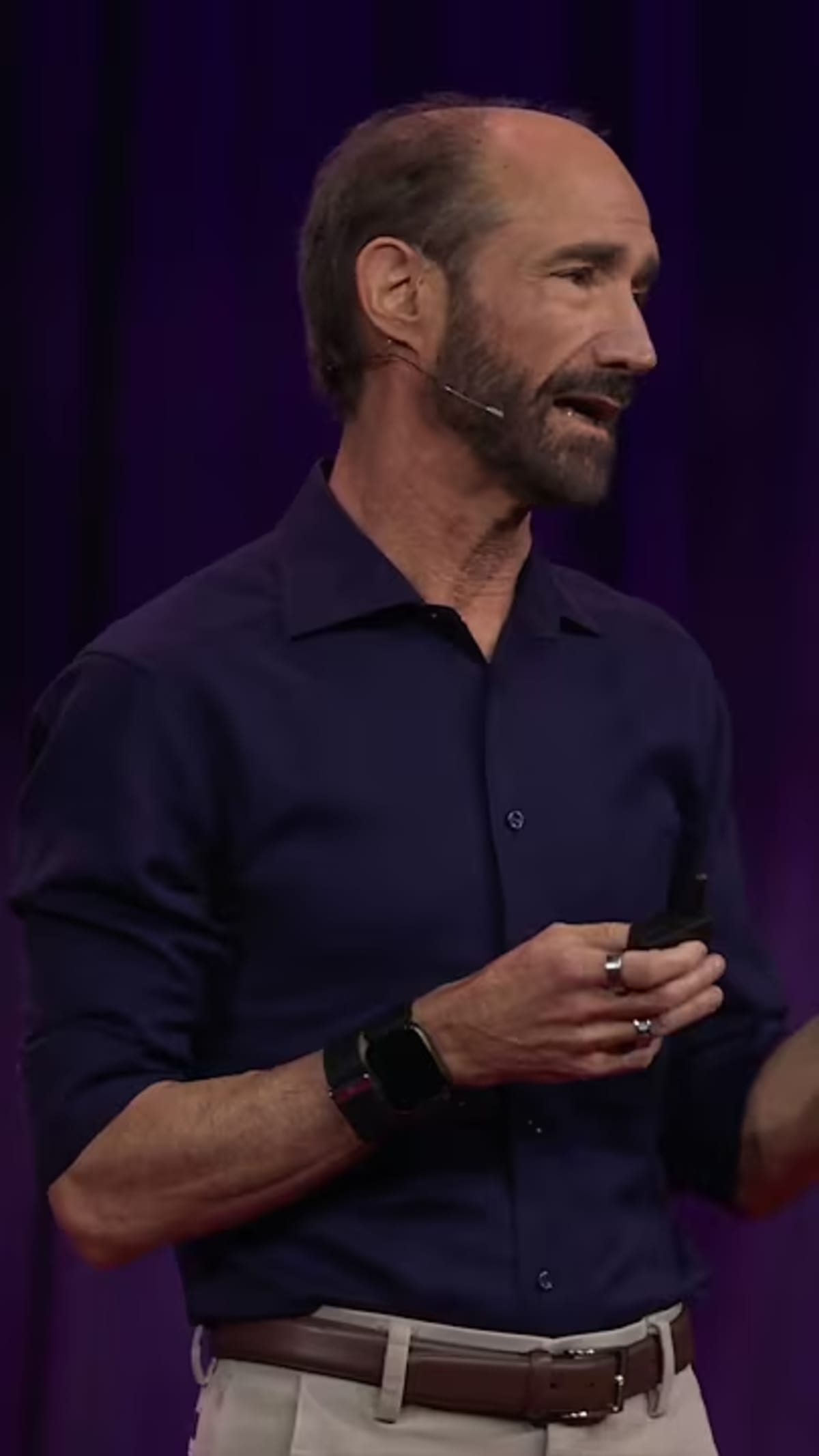 Person checking health data on smartwatch display showing heart rate and activity metrics