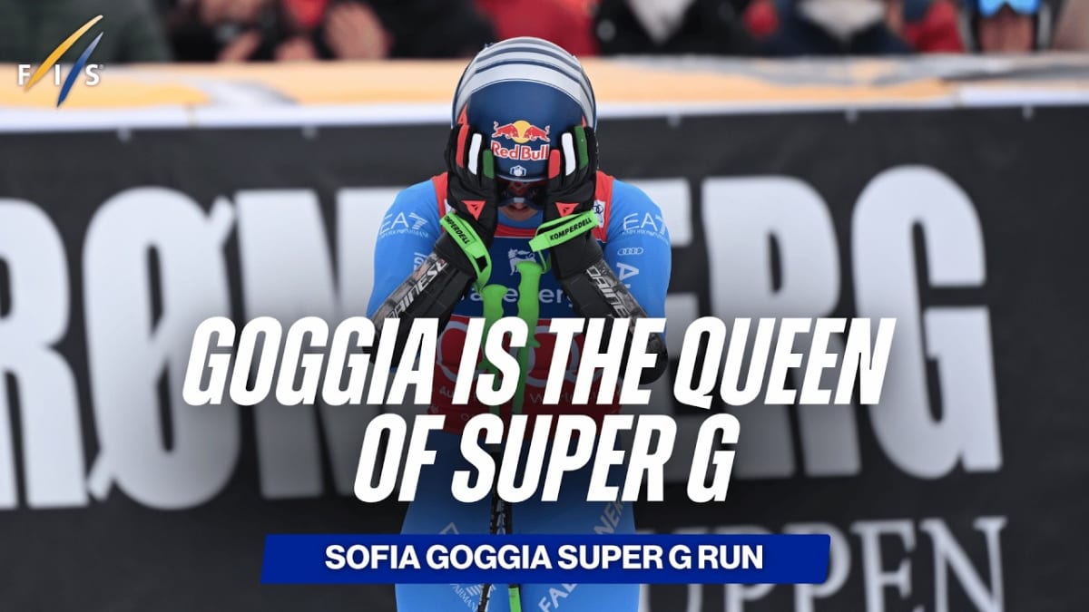 Sofia Goggia celebrates on podium holding Crystal Globe trophy after Super-G victory