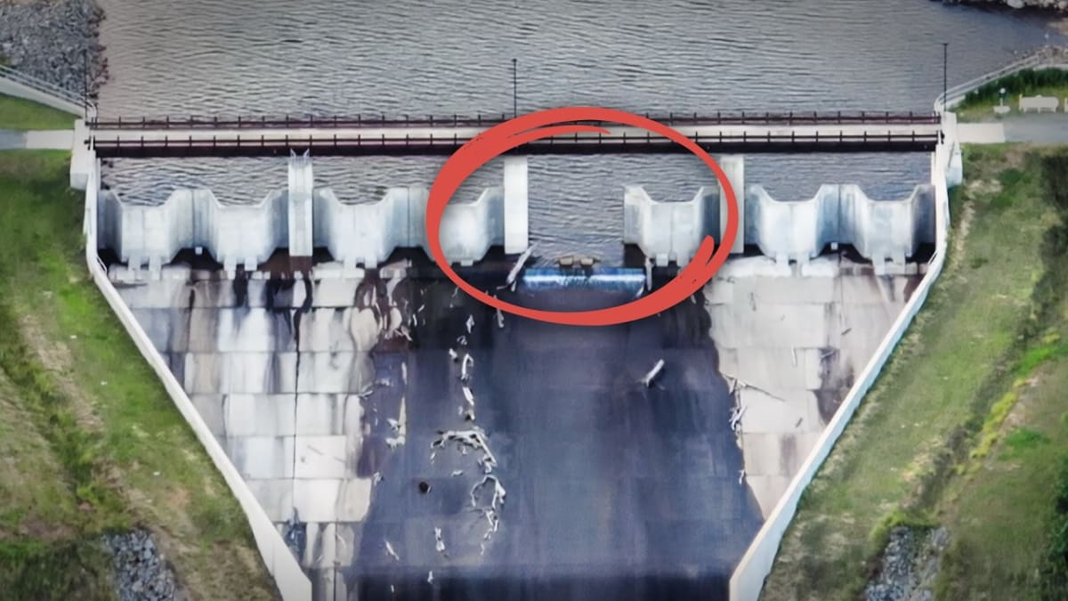 ** Engineering diagram showing fusible gate spillway system on dam structure with water overflow