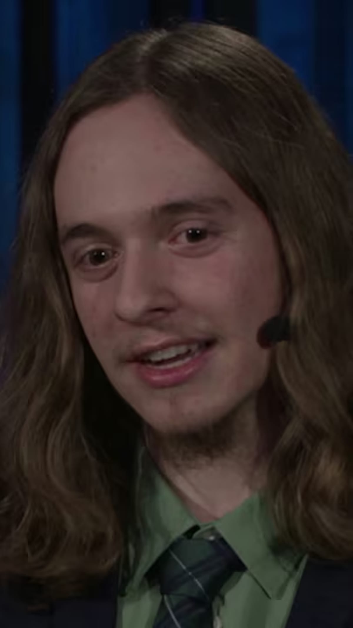 Young speaker Ethan Lisi presenting on TED stage about autism and neurodiversity