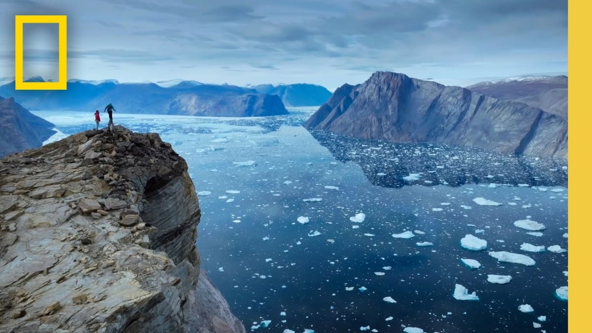 ** National Geographic yellow border frame with lush Earth scenery and families watching together