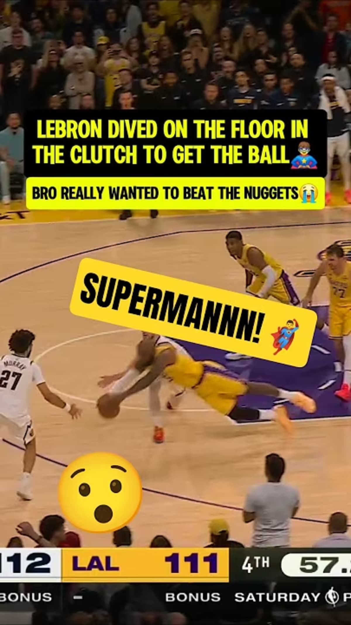 ** LeBron James in Lakers uniform diving horizontally into courtside crowd to save basketball