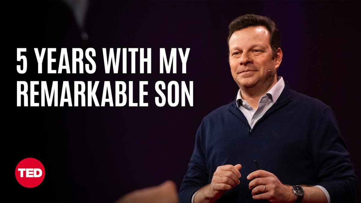 ** Father James G. Robinson speaking on TED stage sharing his son's story