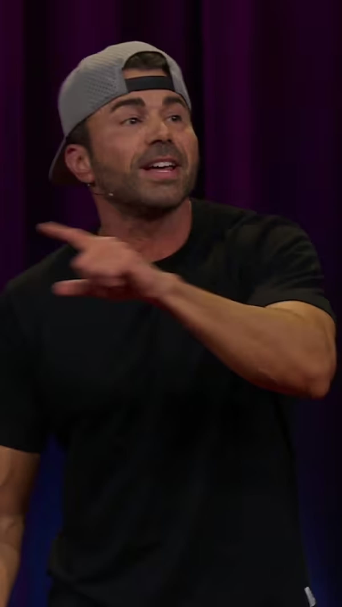 Mark Rober presenting at TED Talk with science demonstration equipment on stage