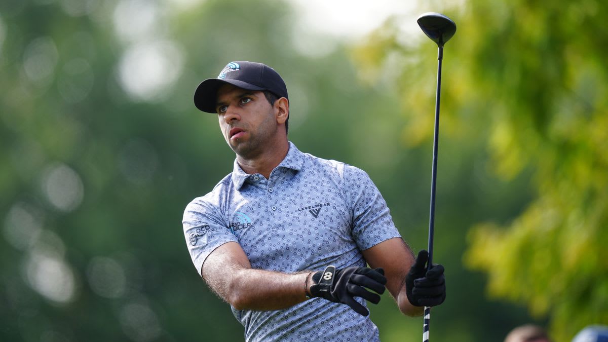 Aaron Rai holding the Wanamaker Trophy on the 18th green at Aronimink Golf Club