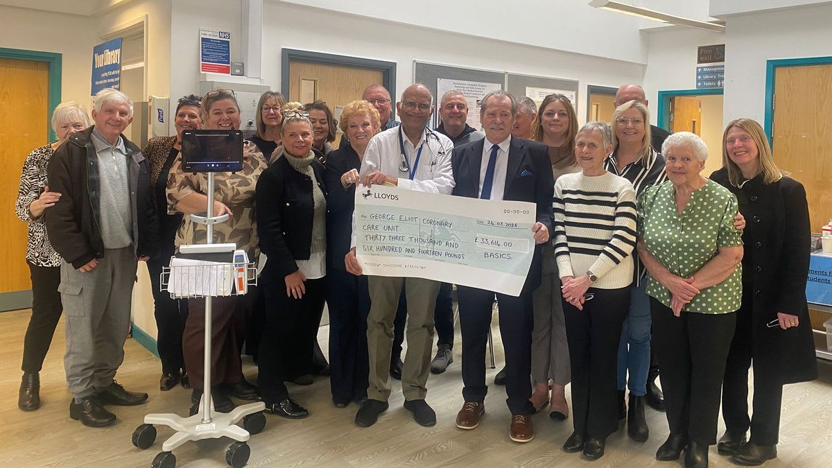 Pete Turner presents oversized check to hospital staff during BASICS charity final donation ceremony